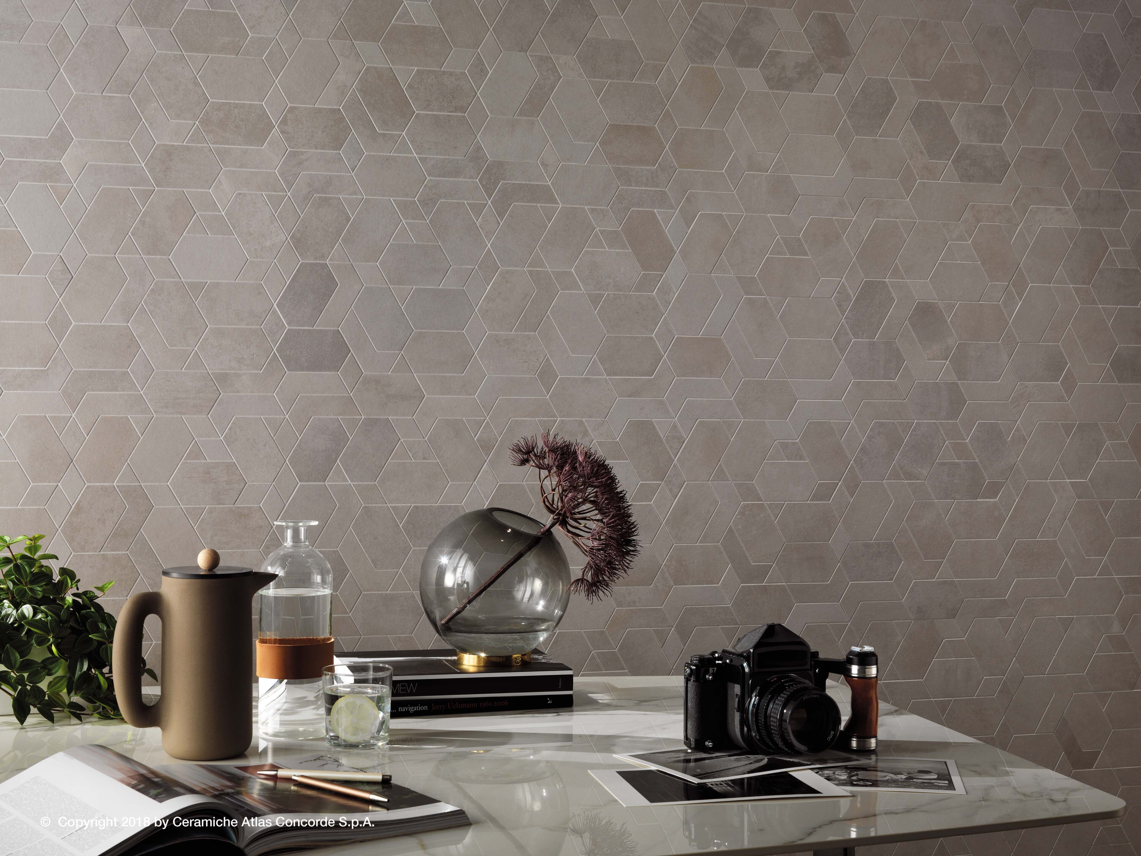 Boost porcelain tile in pearl white shapes mosaic on wall in seating area.