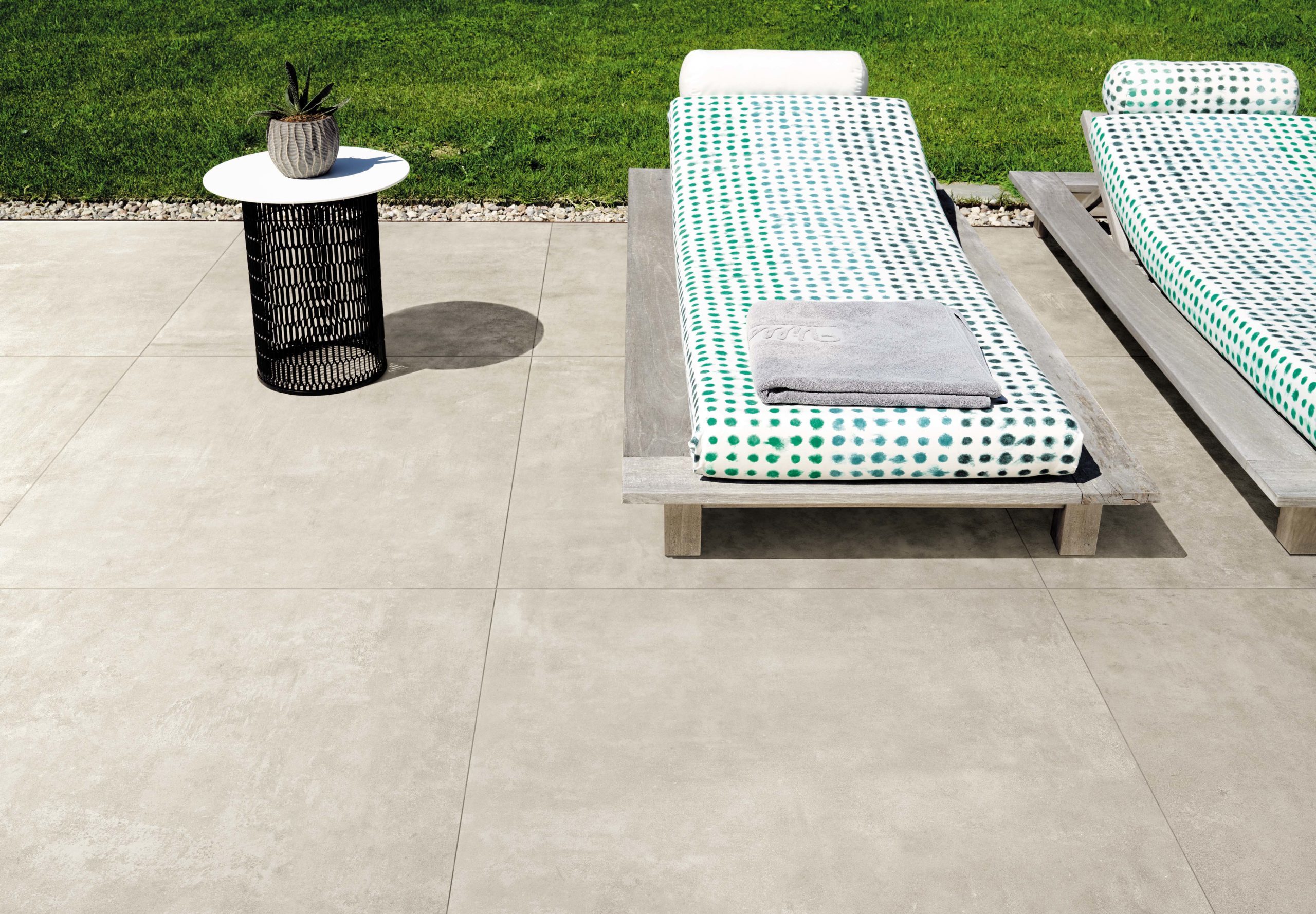 Boost porcelain tile in white installed on the floor in an outdoor area.