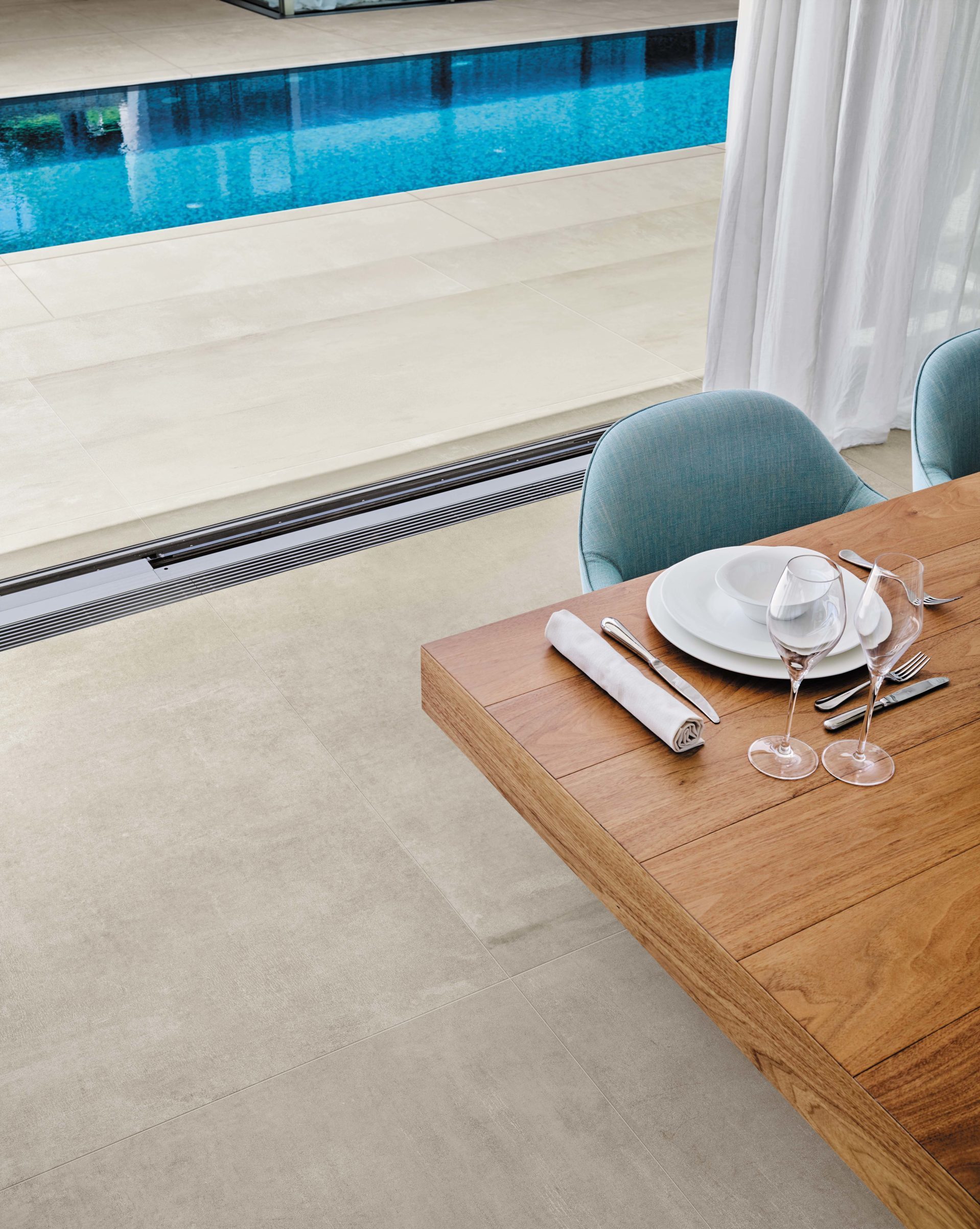 Boost porcelain tile in white installed on the floor in an indoor-outdoor area.