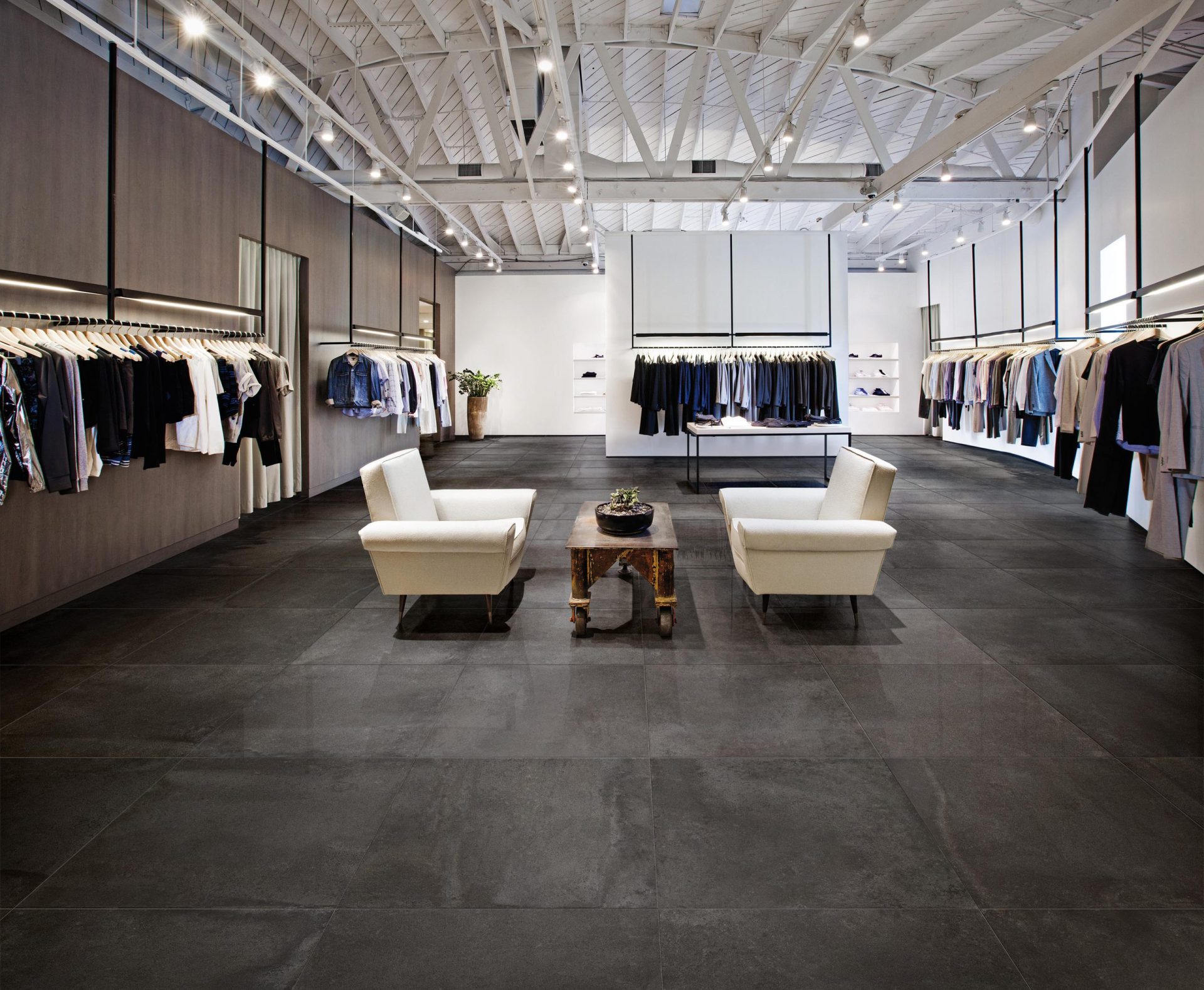 Bits pitch black porcelain tile on the floor in a retail store.