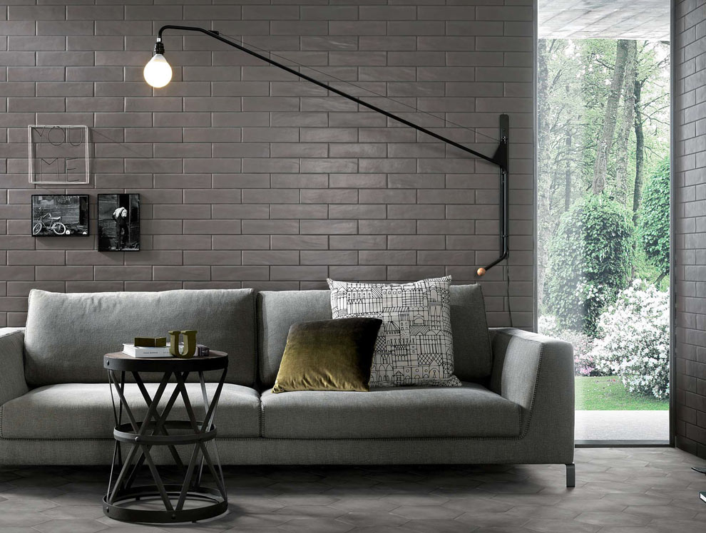 Cemento Boston porcelain on walls behind couch in modern living room