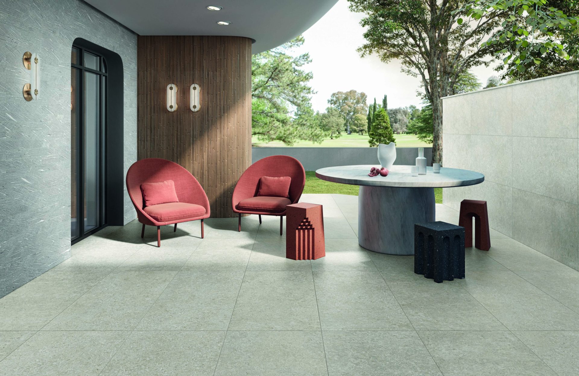 Outdoor seating area showing Tide Road porcelain tile in Platinum Vein cut on the wall and Light Cross cut on the floor.
