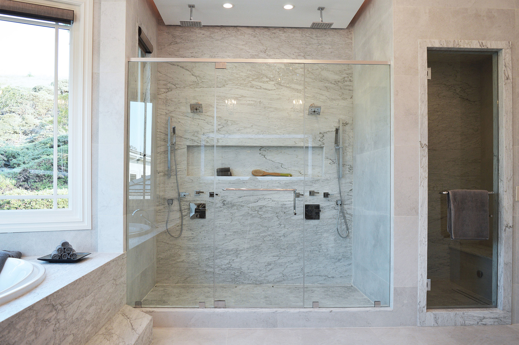 Bianco Carrara marble with a moonface finish featured in a shower design