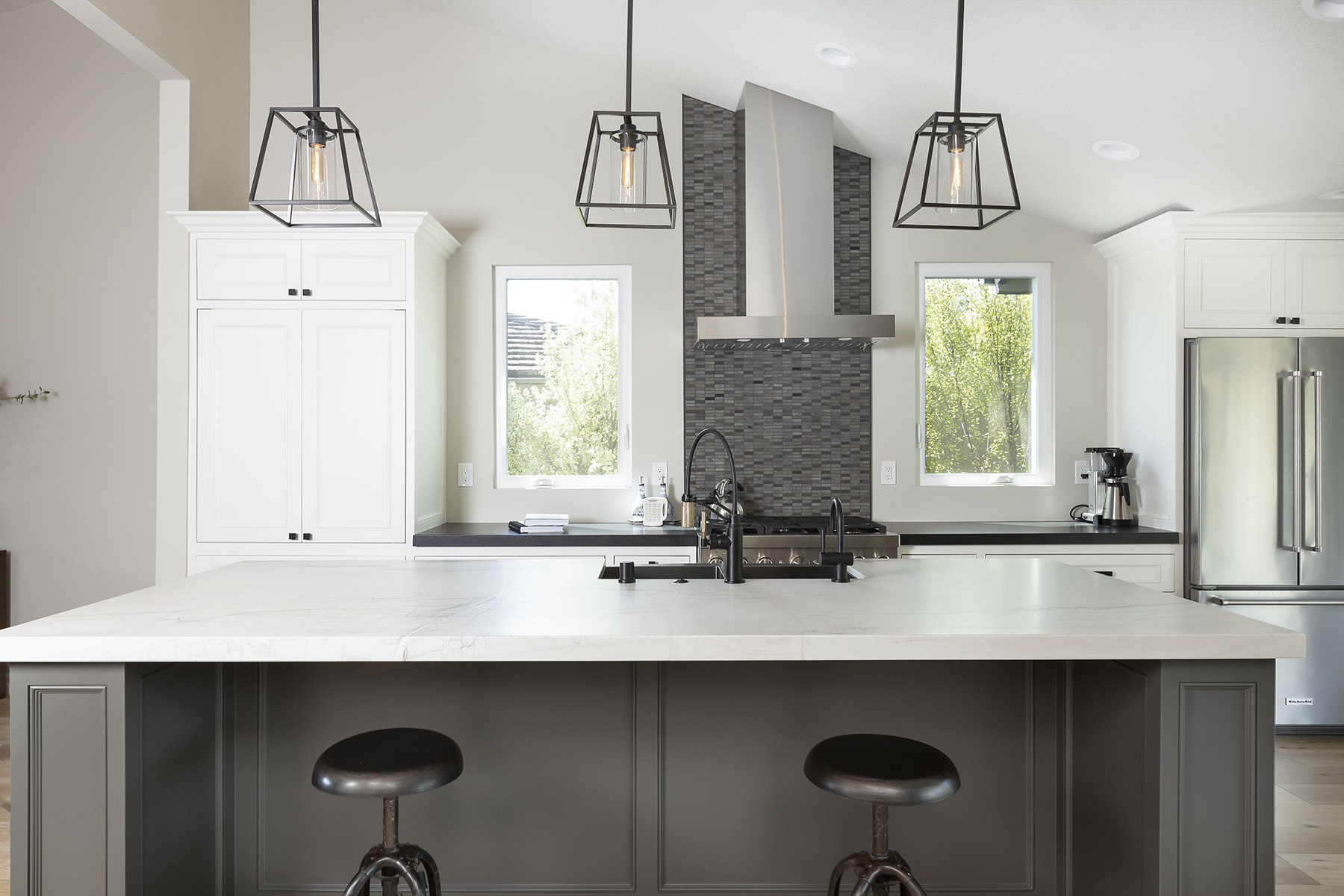 Luce Di Luna quartzite featured in kitchen with white cabinets
