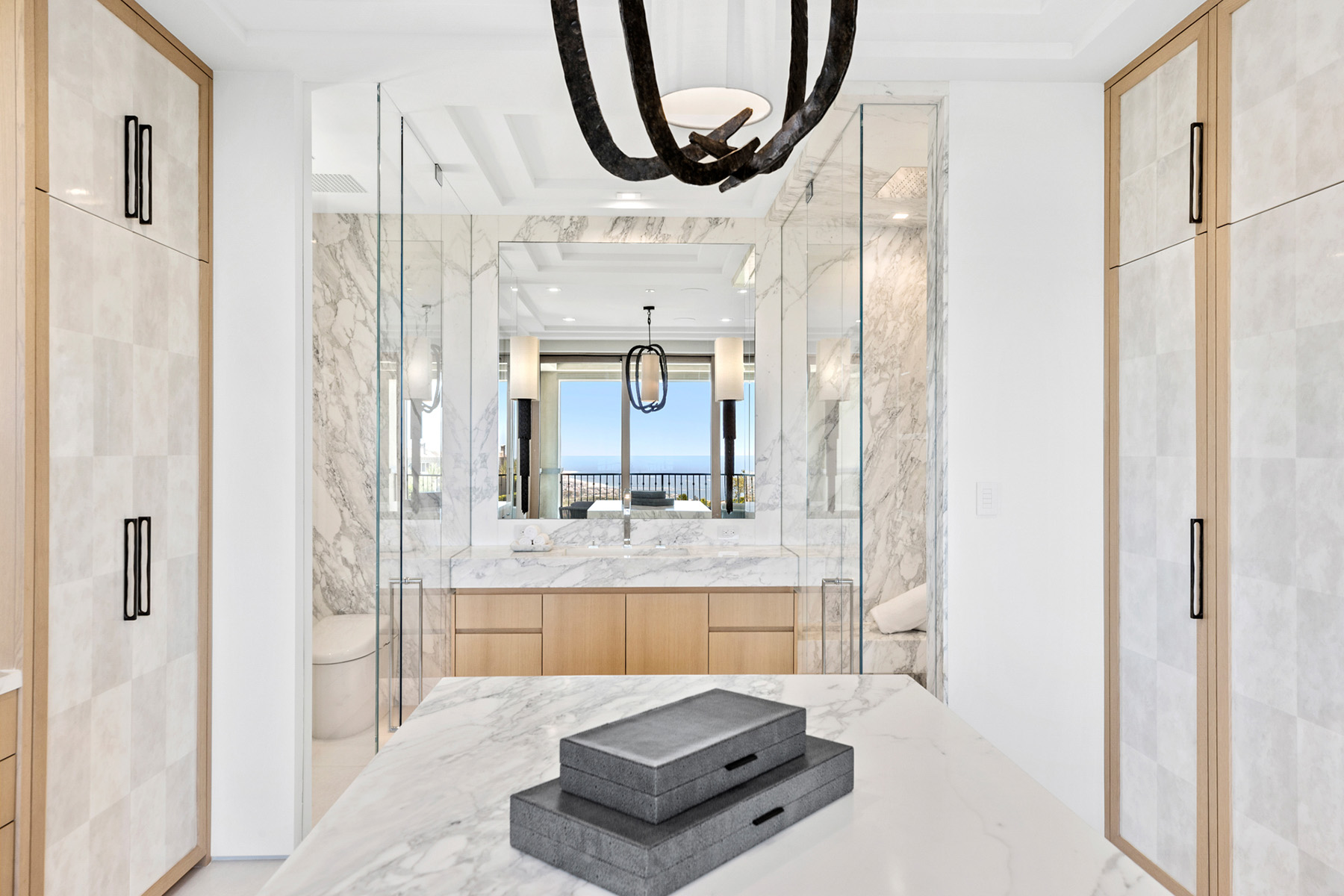Calacatta marble featured in modern bathroom with white cabinets