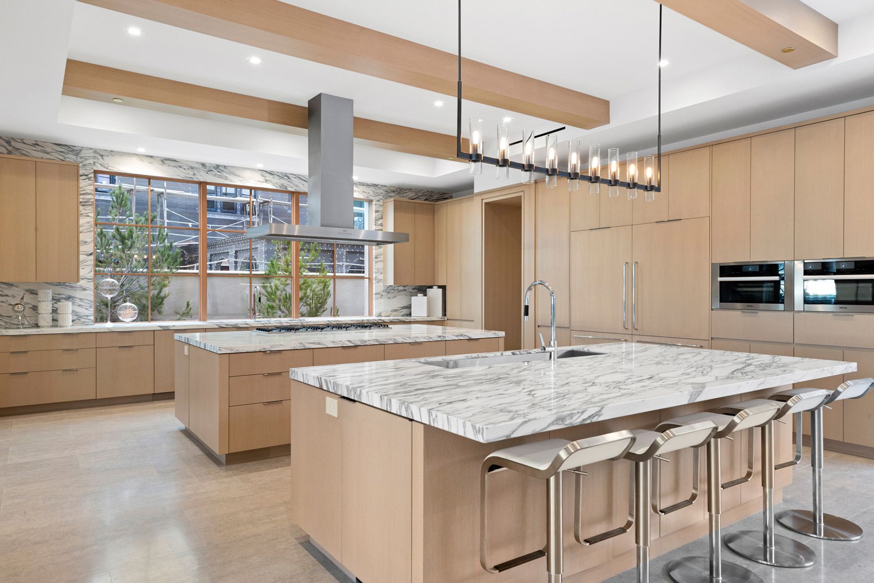 Arabescato Corchia marble featured in modern kitchen with beige cabinets