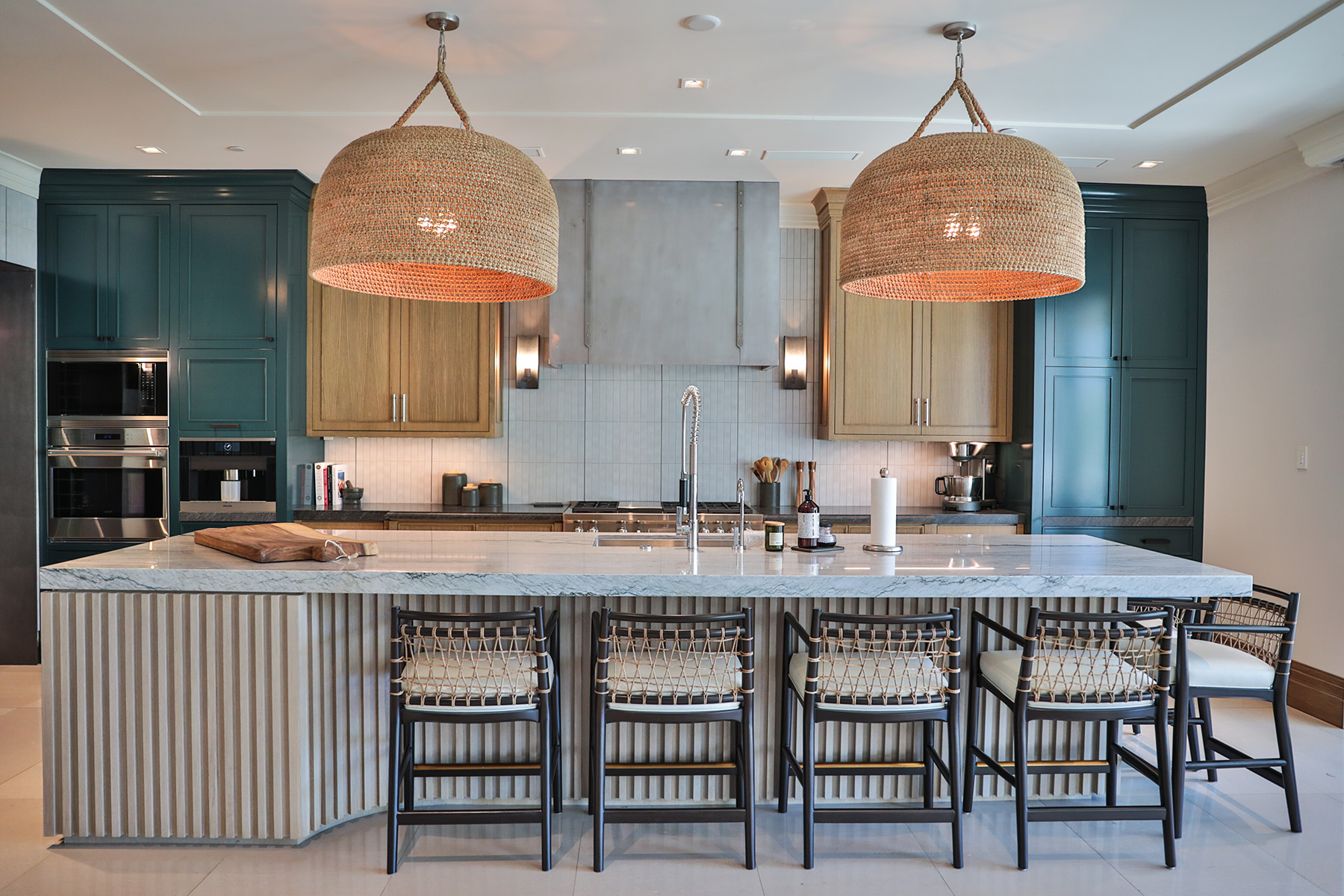 White Pearl quartzite featured in modern kitchen with green cabinets