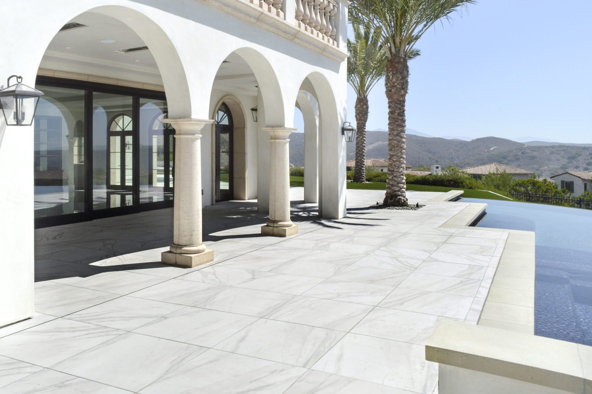 Calacatta Gold porcelain pavers installed in outdoor pool space