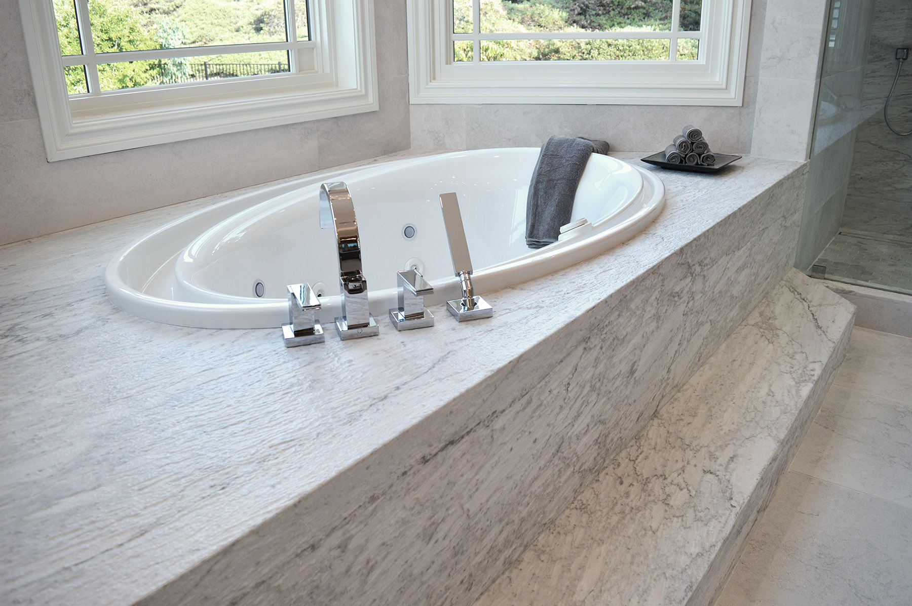 Bianco Carrara moonface finish marble featured on bathtub