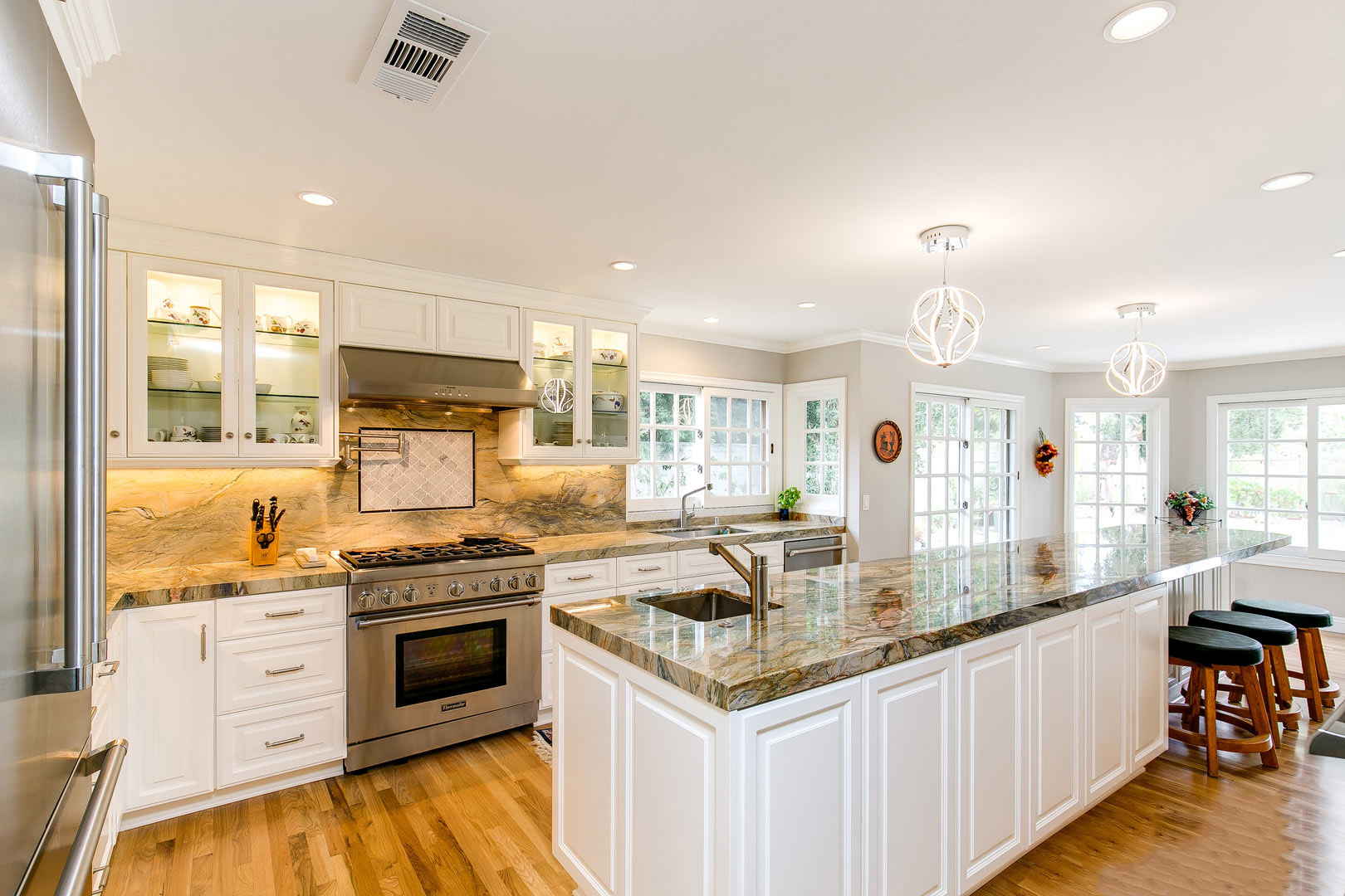 Fusion granite featured in modern kitchen with white cabinets
