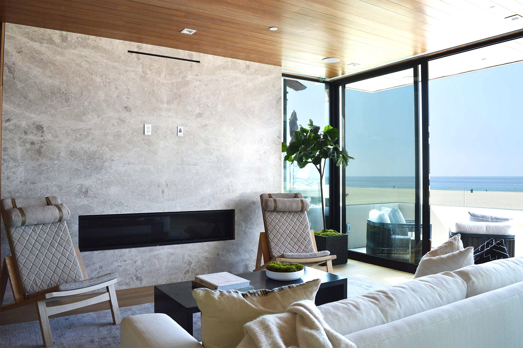 Tundra Silver marble fireplace featured in beachside home living room