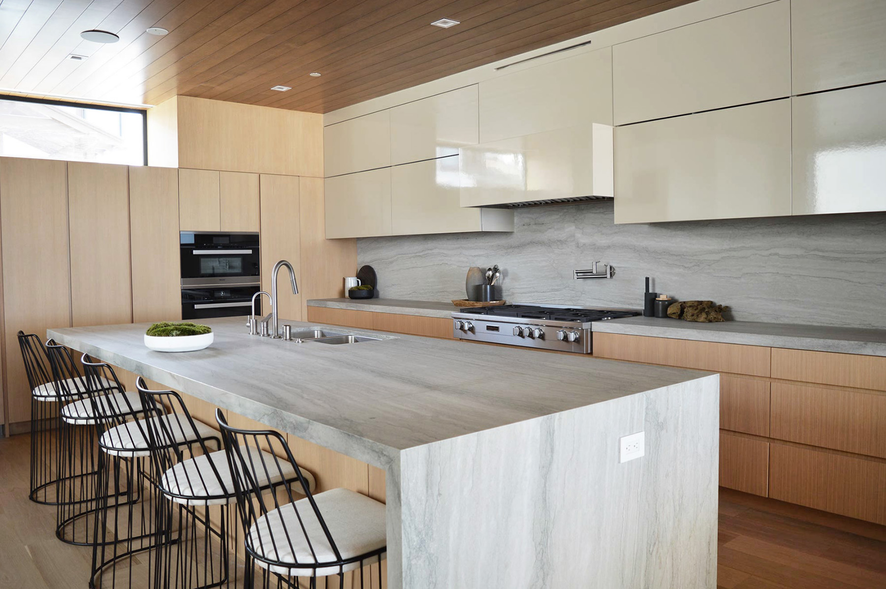 White Pearl quartzite featured in modern kitchen with beige cabinets