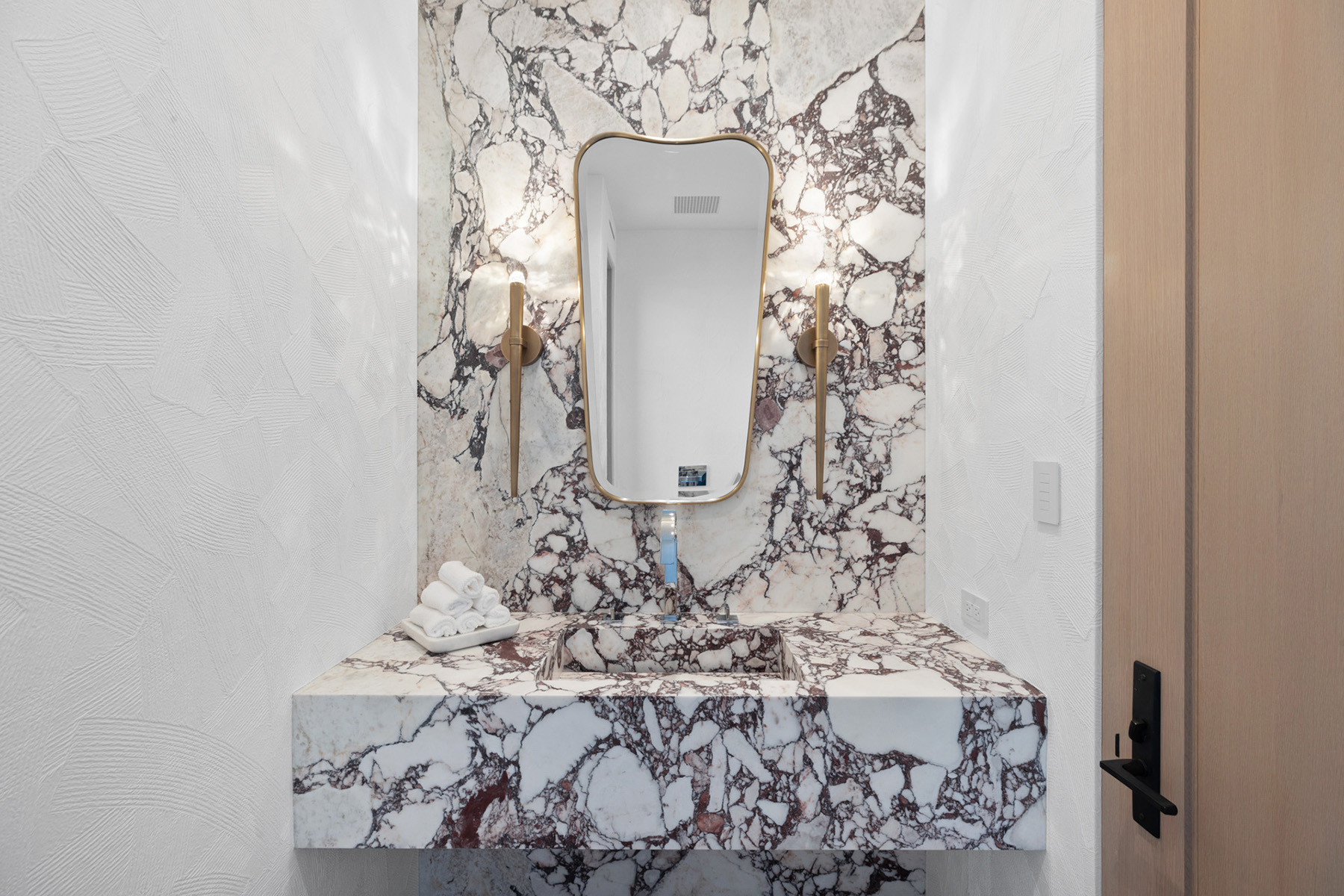 Calacatta Viola marble featured on modern bathroom countertop and backsplash