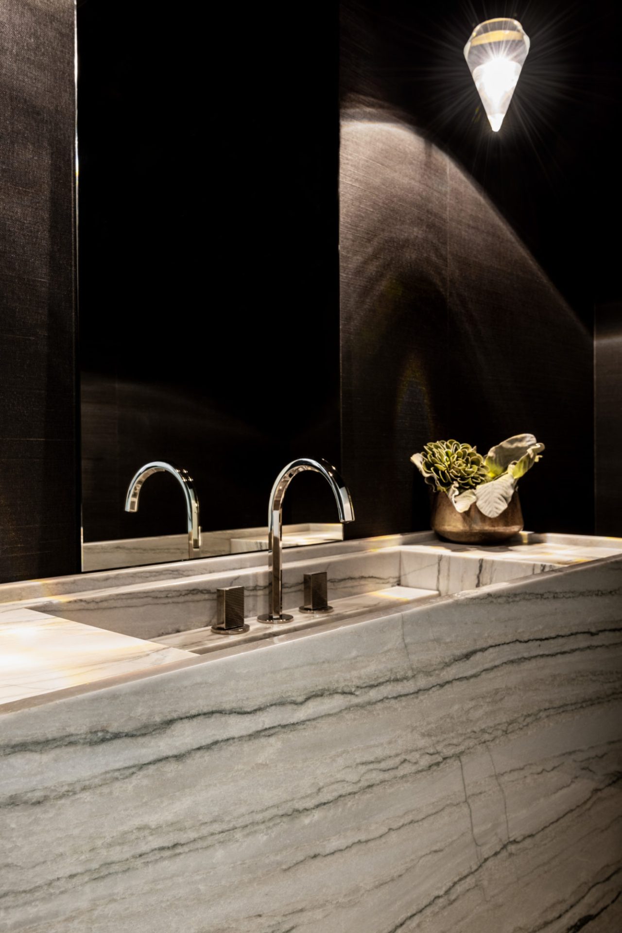 Moody powder room featuring white macaubas quartzite vanity
