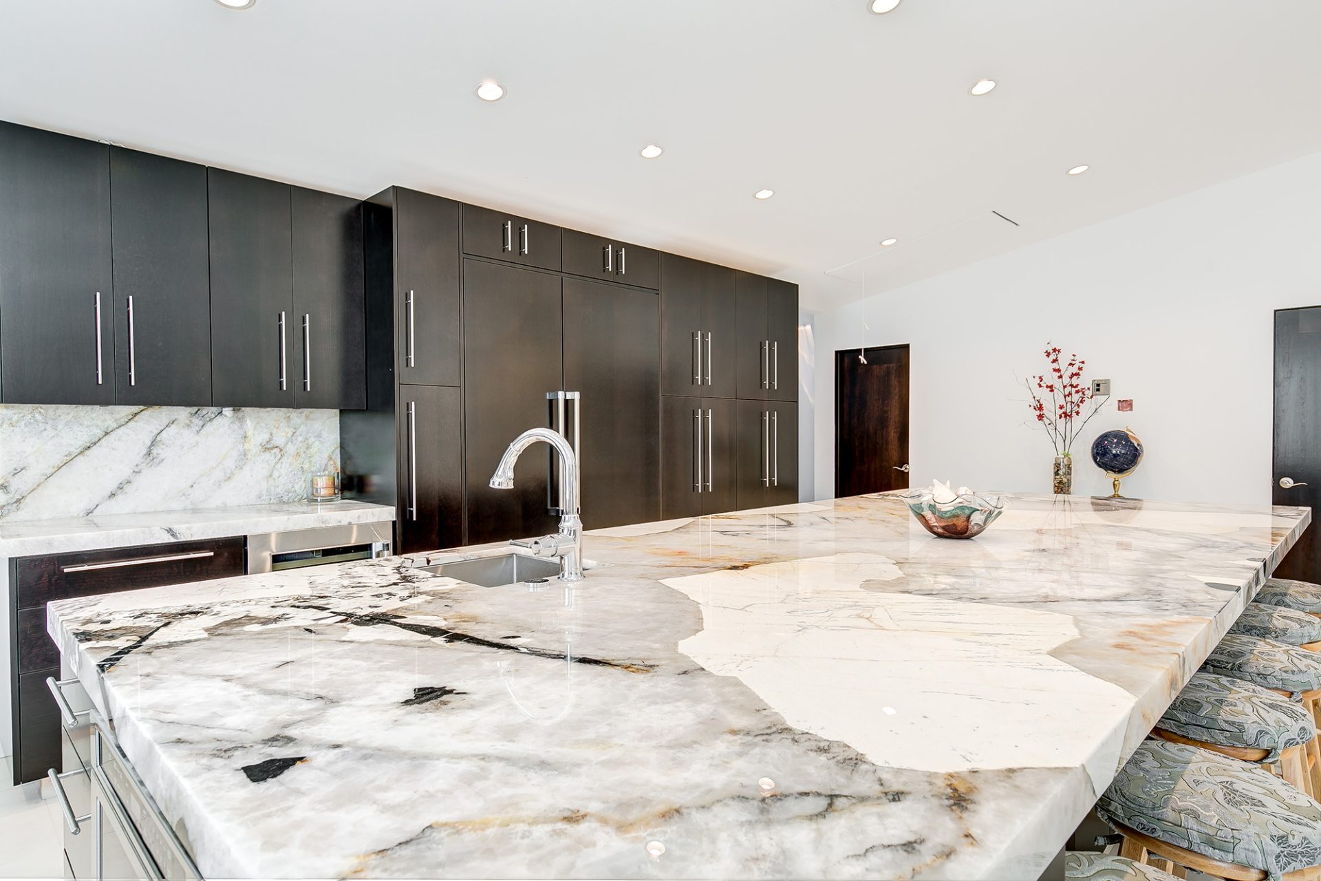 Patagonia quartzite kitchen island with black cabinets