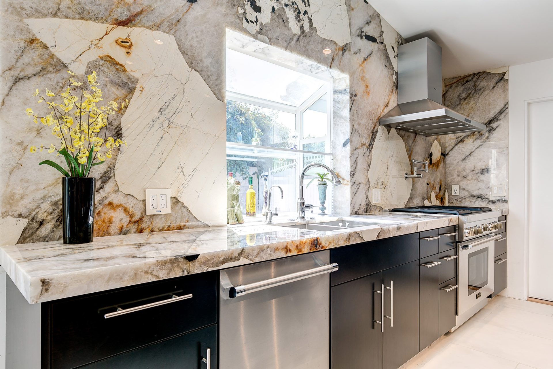 Patagonia quartzite featured in modern kitchen with black cabinets
