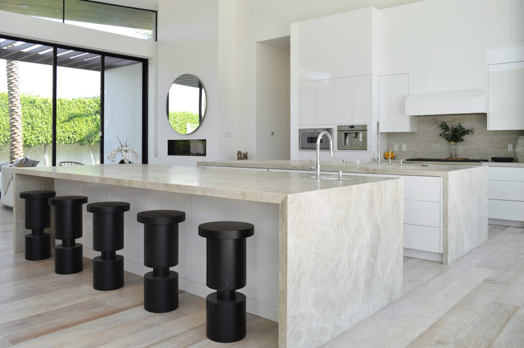 Tajmahal quartzite featured in modern kitchen with white cabinets