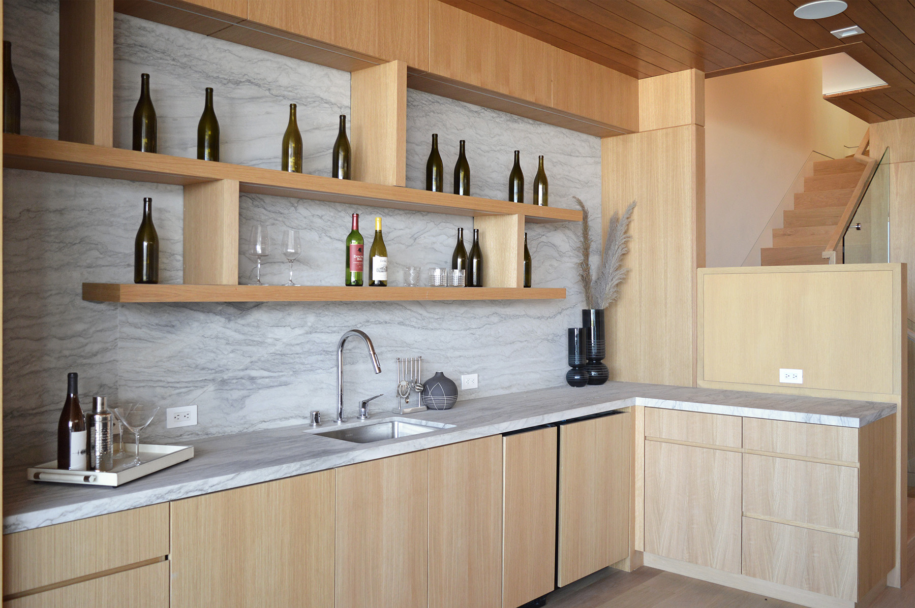 White Pearl quartzite installed on backsplash and countertop with beige cabinets