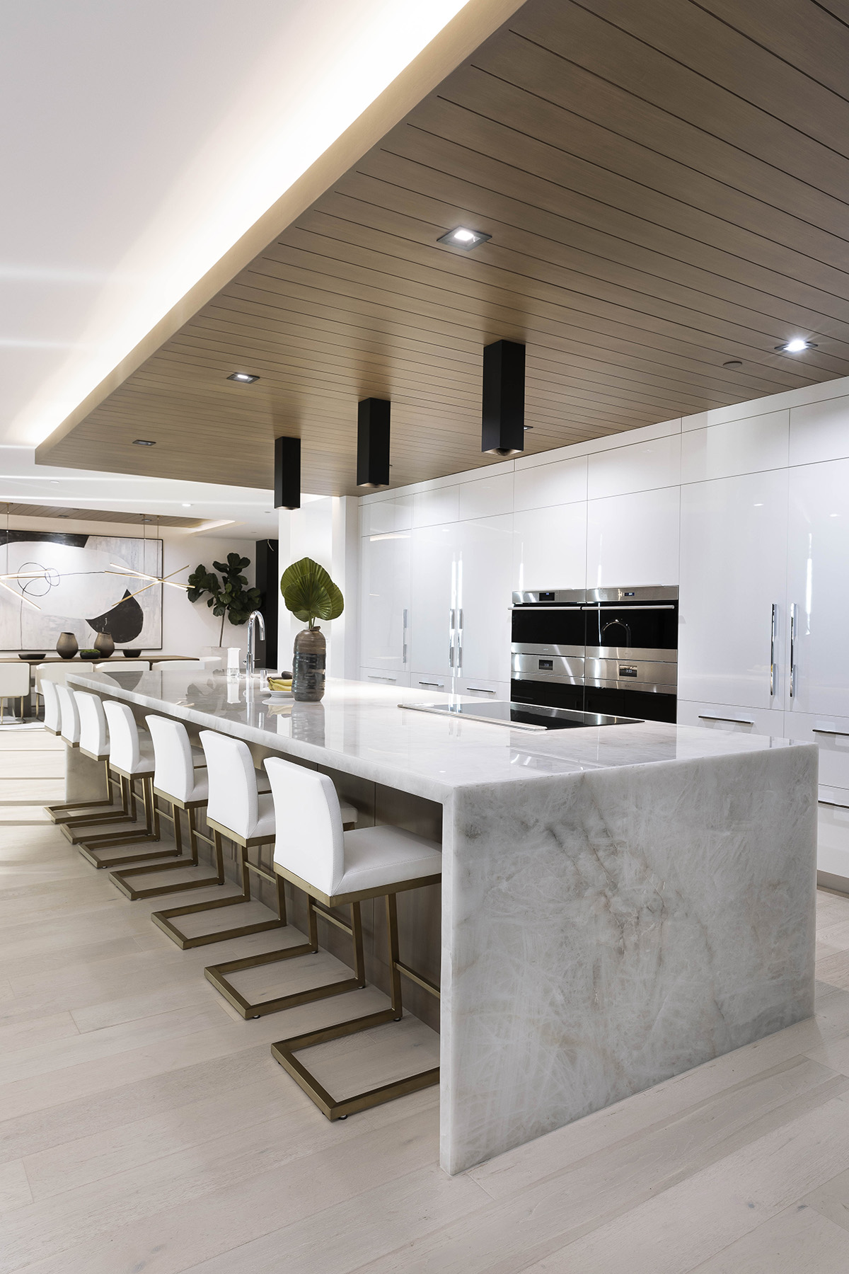 Lumix quartzite installed on kitchen island with white chairs