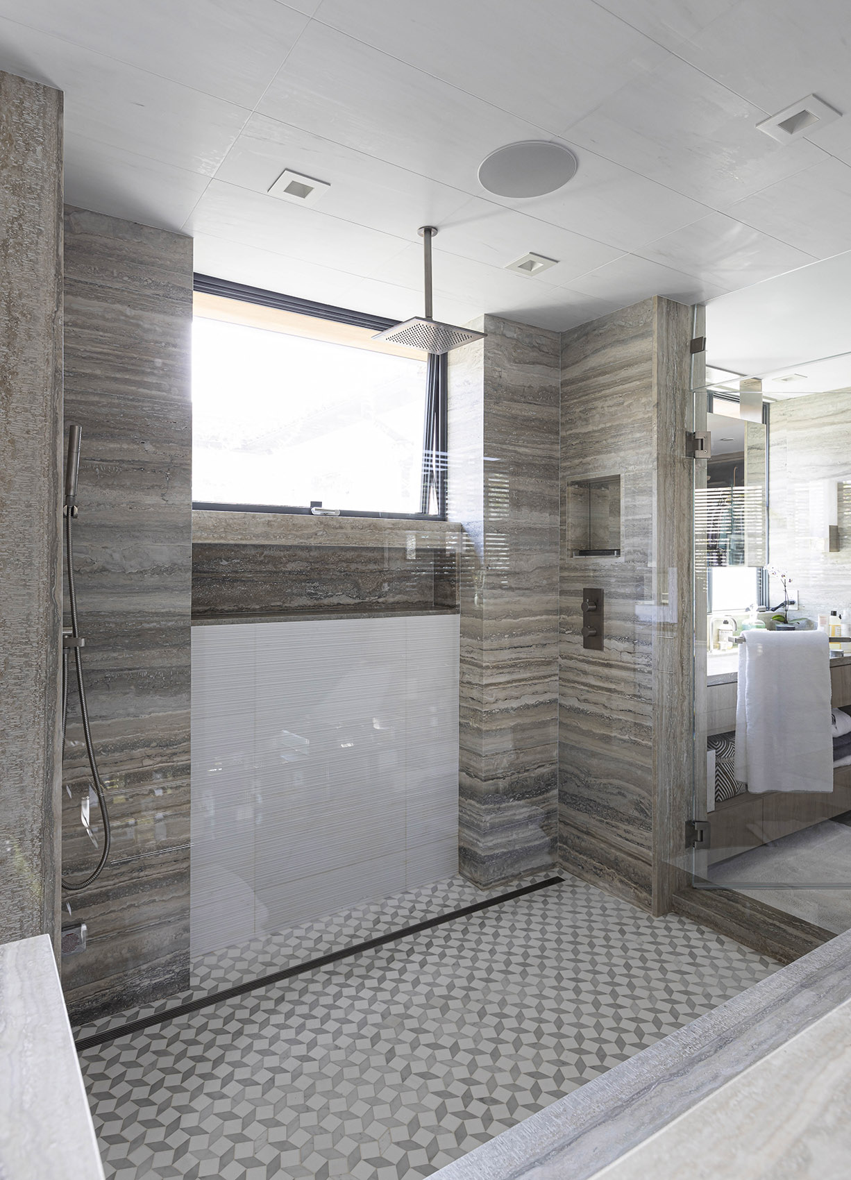 Tuscany Silver travertine installed in shower with mosaic flooring
