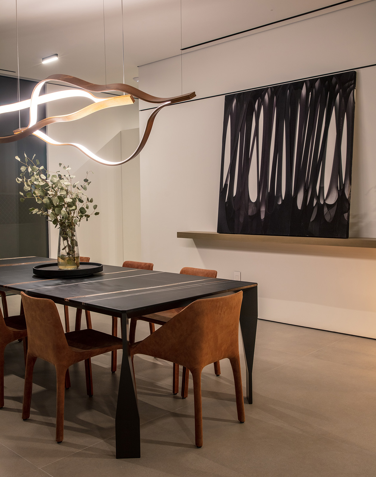 Noir St. Laurent marble featured in dining room with black art piece