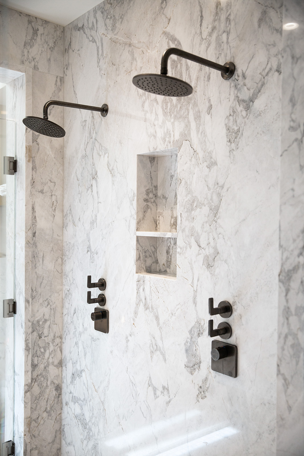 Calacatta Matarazzo dolomite installed in shower with black accents