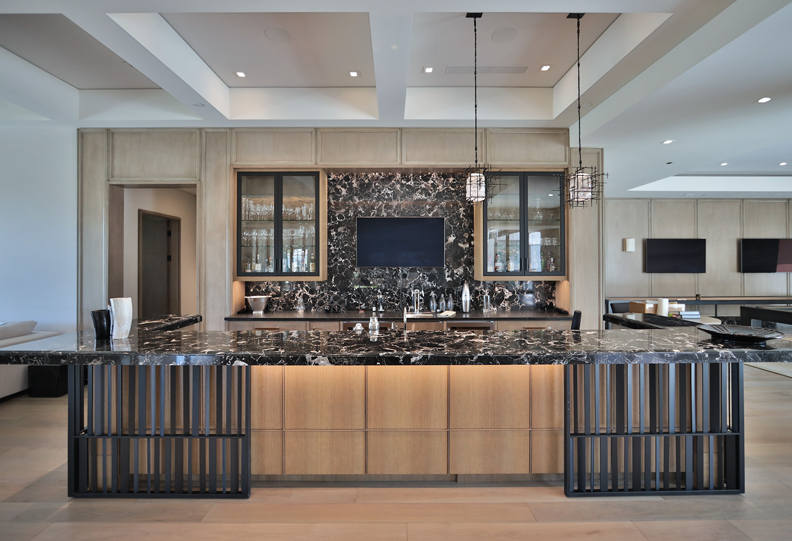 Ice Black marble featured in bar with beige cabinets
