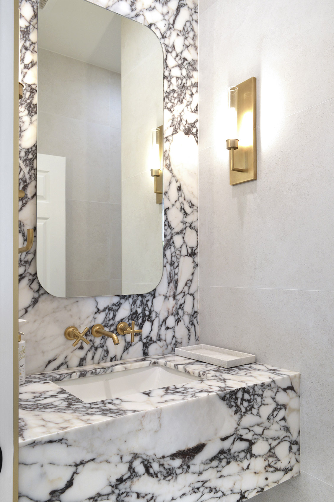 Breccia Viola marble featured on bathroom vanity with gold accents