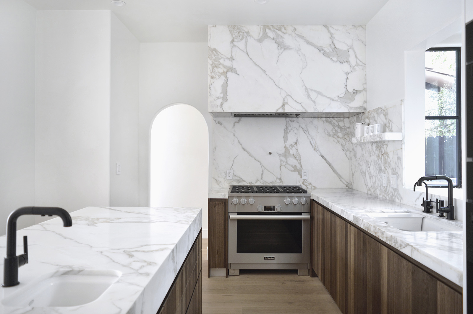 Calacatta Borghini marble featured in modern kitchen with brown cabinets
