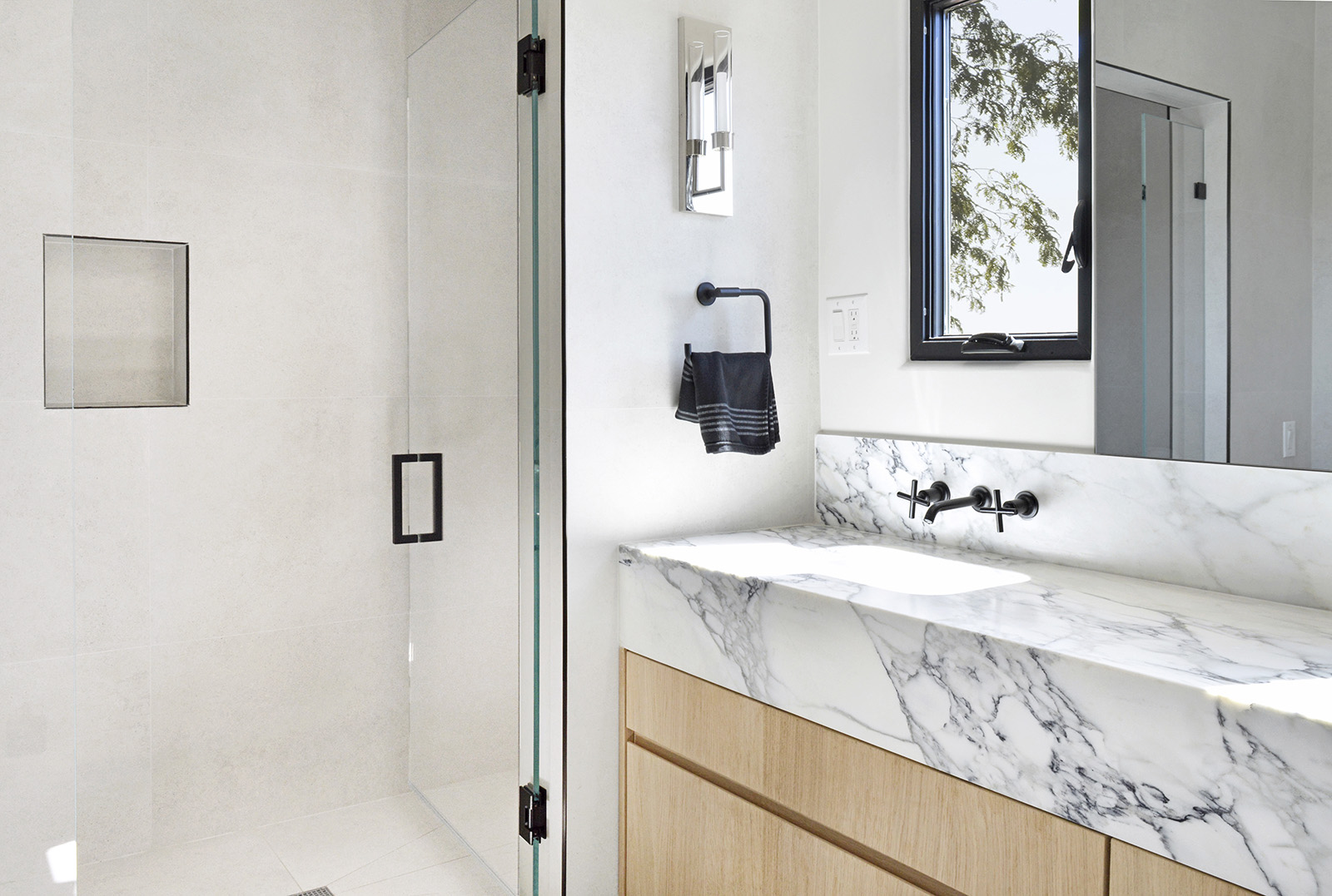 Calacatta Monet featured in bathroom with a Pietra Della Seta Light porcelain tile shower