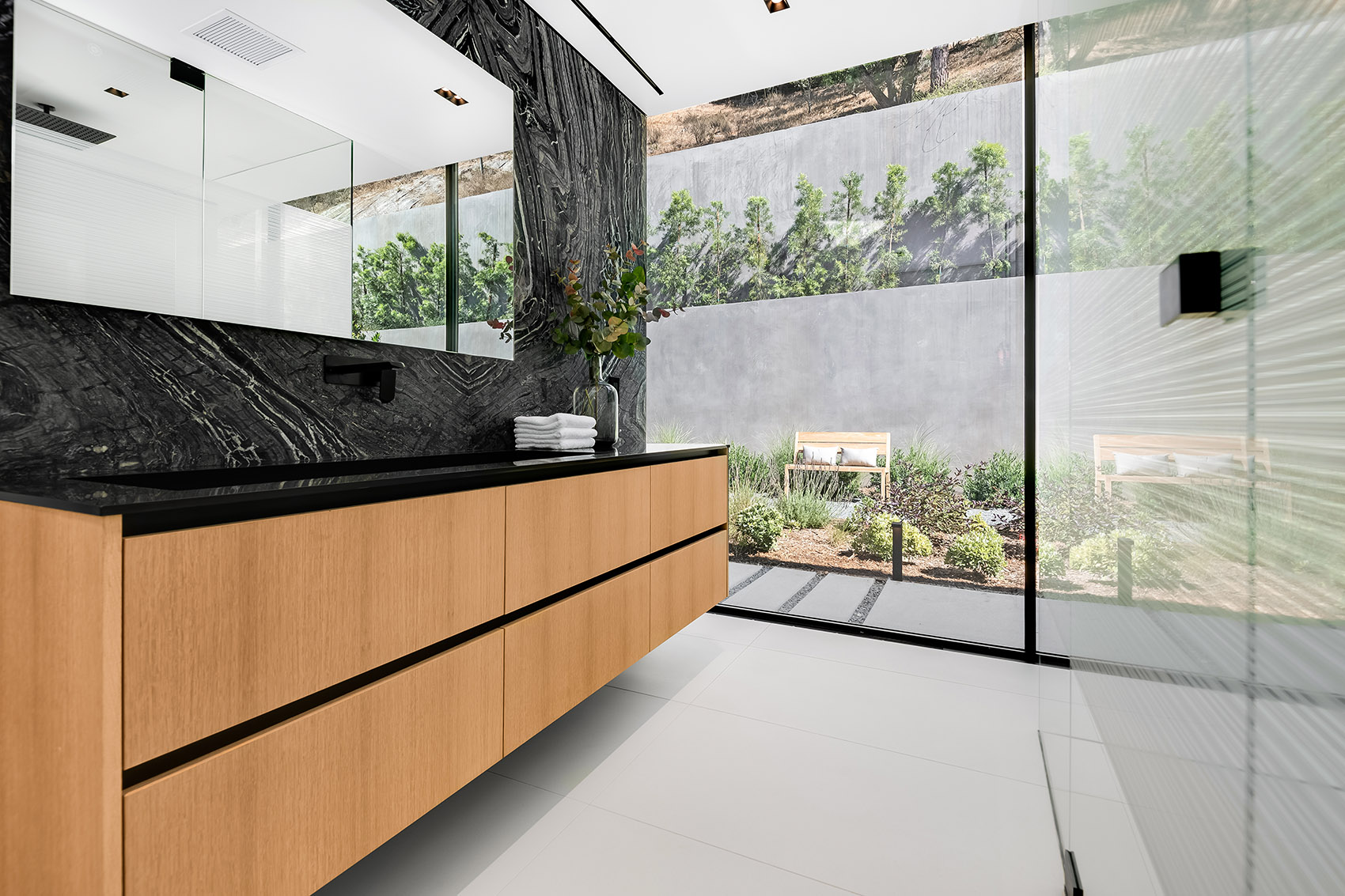 Silver Wave marble featured in modern bathroom with beige cabinets