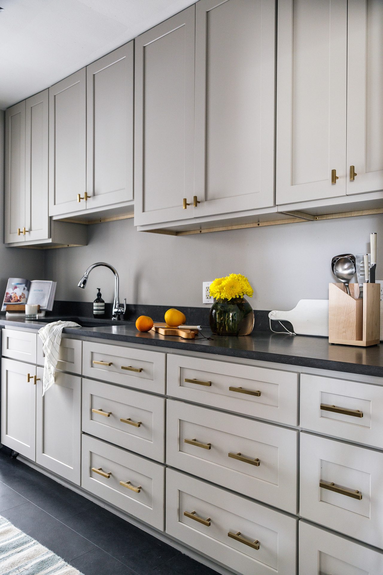 MetroQuartz Fortress Honed featured in modern kitchen with grey cabinets