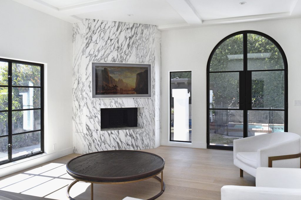 White stone fireplace in white living room