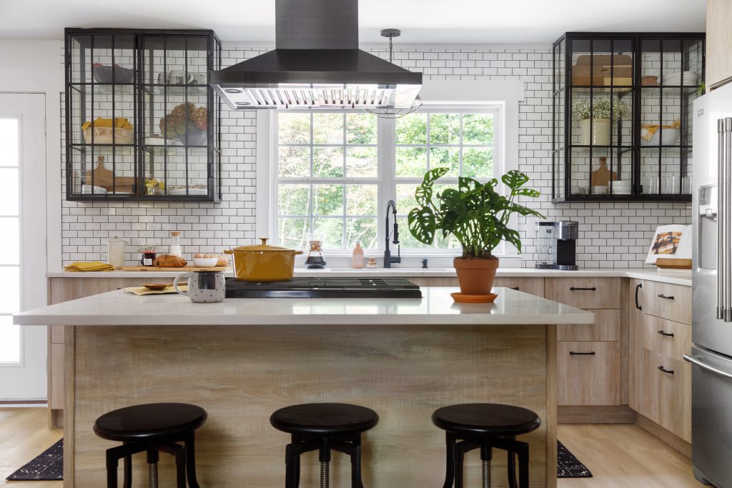 Luce Viaggo countertops in white and black kitchen with wood cabinets.