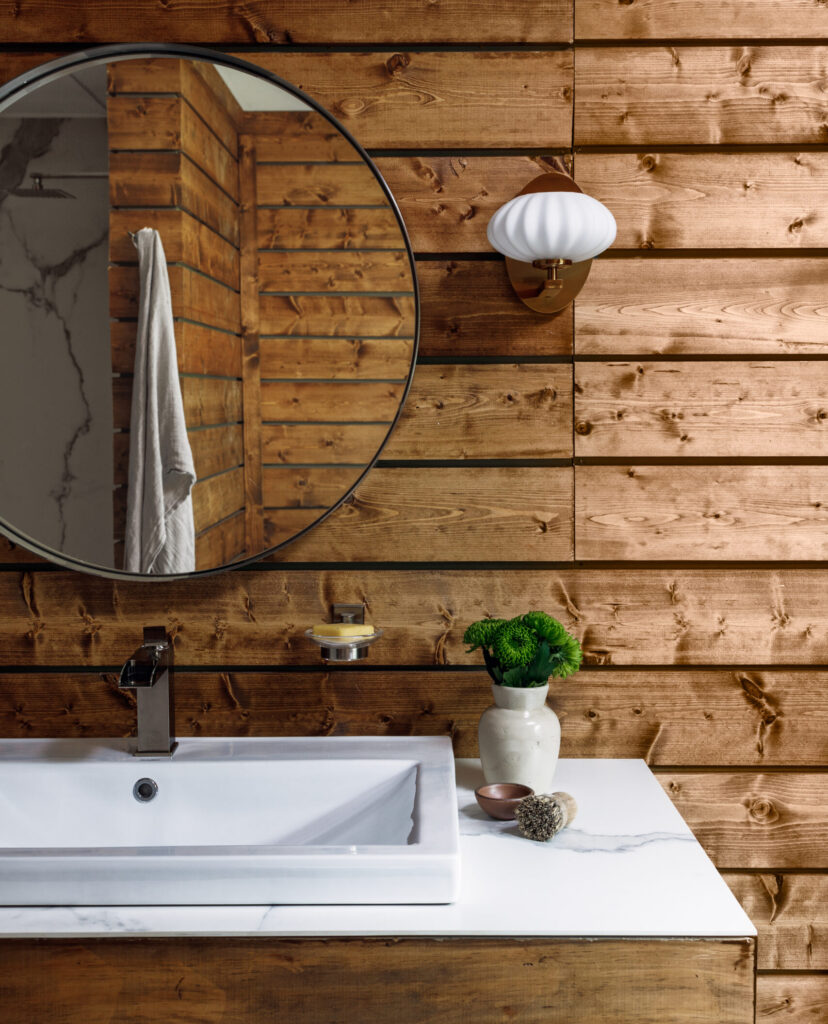 Unique Calacatta Gold is installed in a bathroom with wood walls