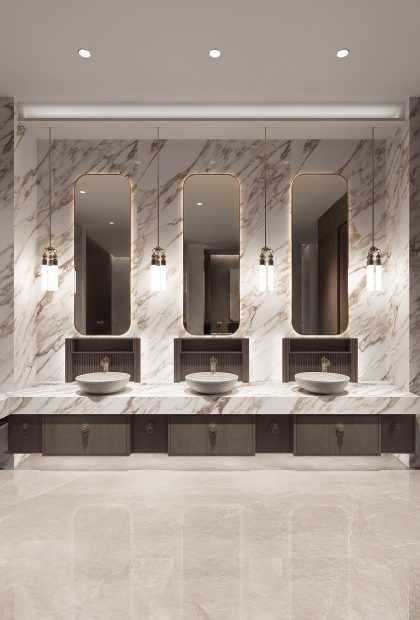 AuthTerra Calacatta Vagli Gold 9105 wall cladding and vanity countertop in a luxury commercial restroom with three sinks