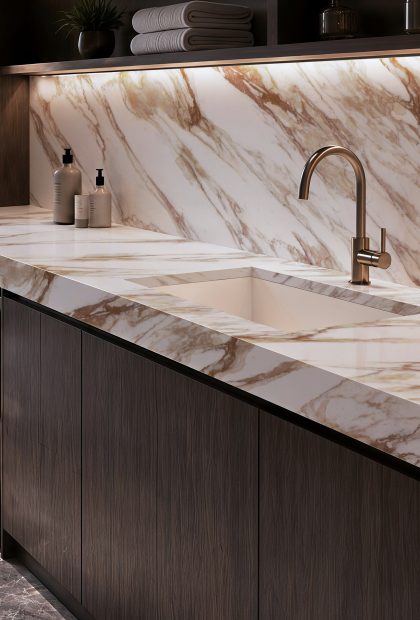 AuthTerra Calacatta Vagli Gold 9105 waterfall countertop and full-height backsplash in a modern laundry room