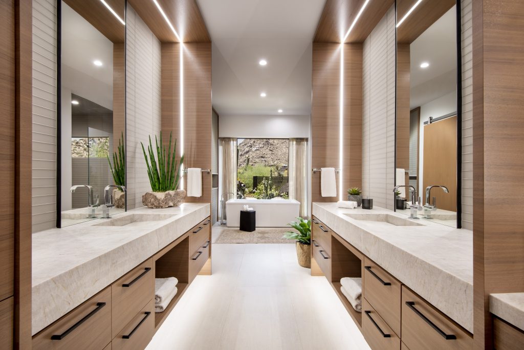 Double bathroom vanity with Taj Mahal quartzite countertops and warm wood cabinetry